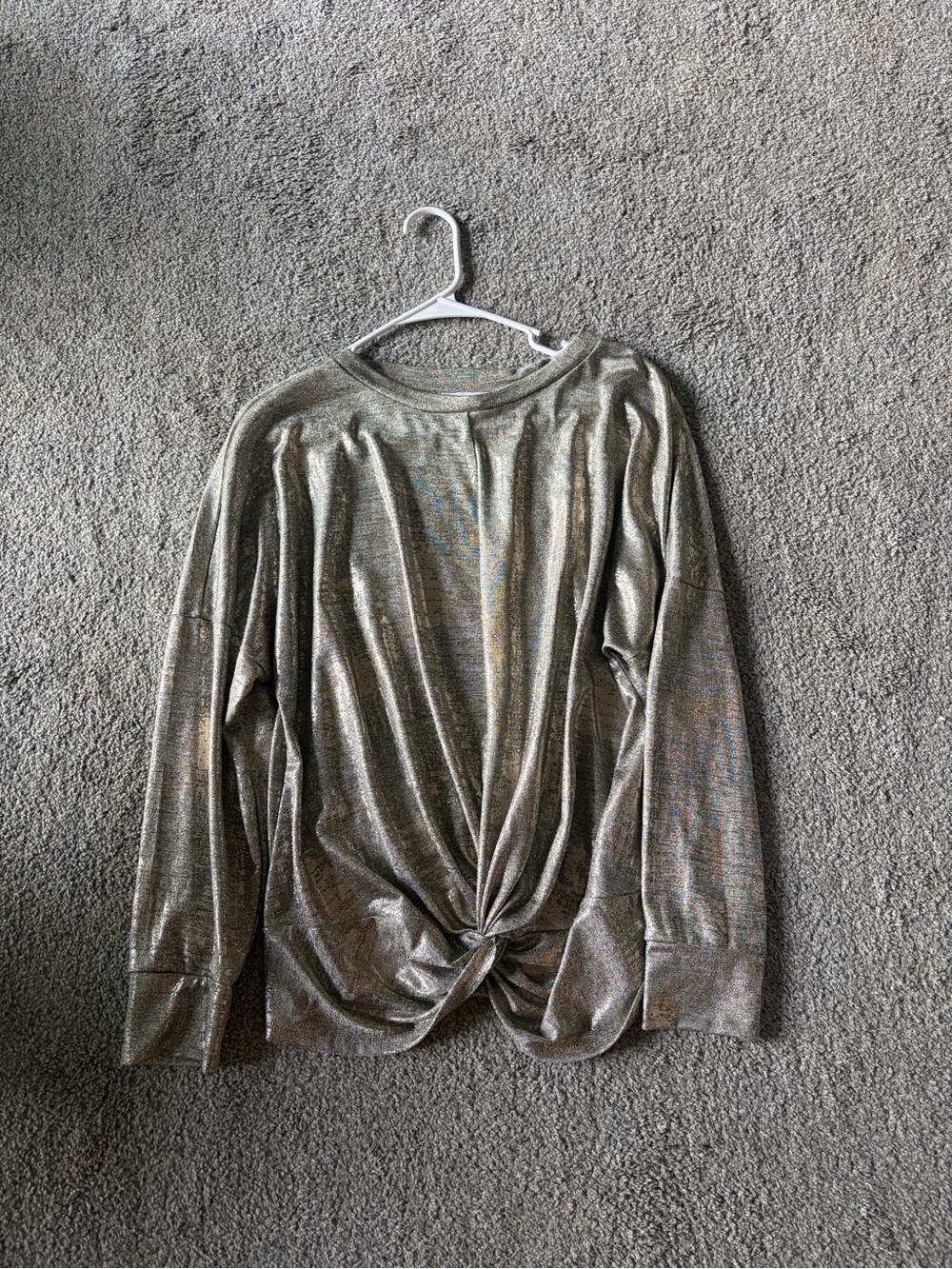 Silver metallic long sleeve top with twist detail on bottom